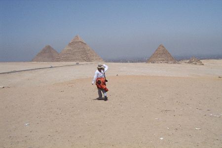 Jayne walking in the desert towards the pyramids